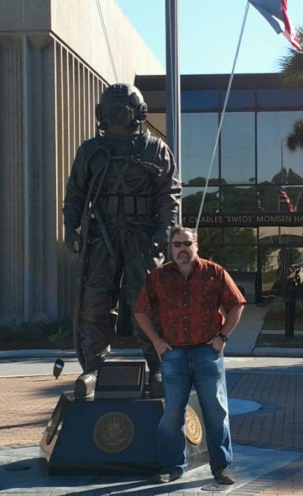 Richard Phillips Standing Beside the Statue