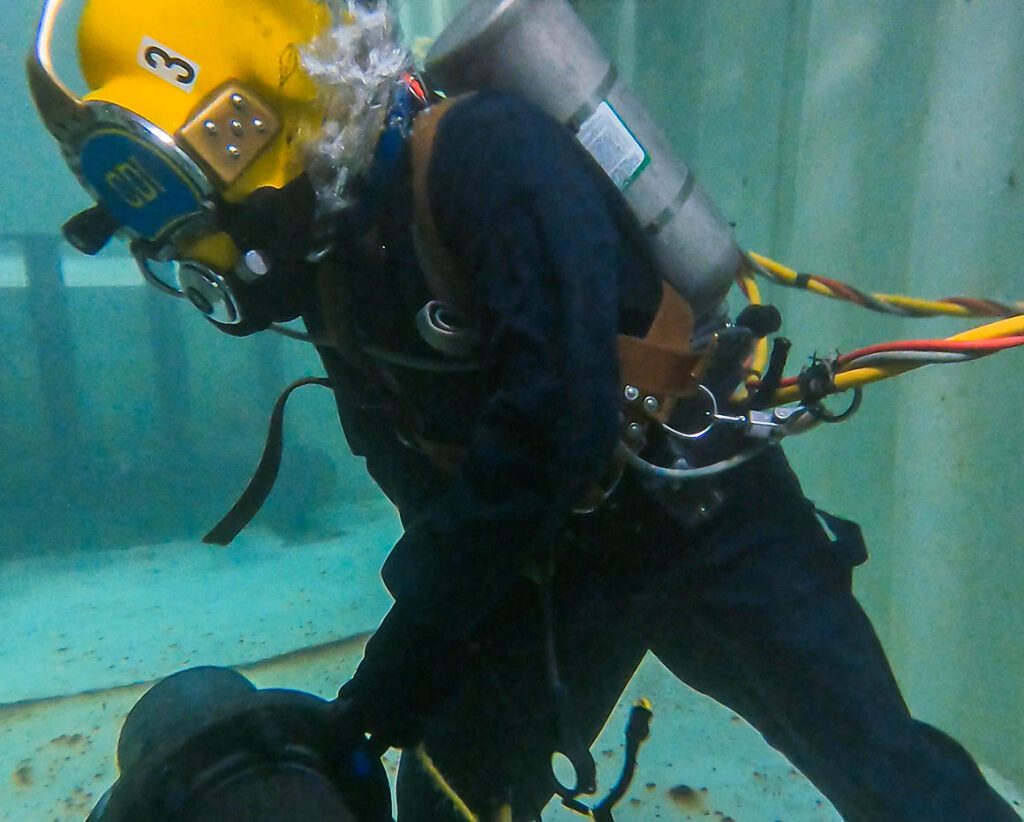 A Person in a Scuba Gear in a Container Tank